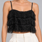 Top Dixie nero con frange su modella – dettaglio