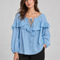 Blusa azzurro cielo con volant e laccetti – fronte su modella